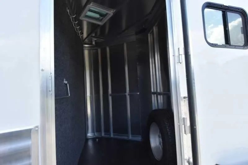 2018 Lakota 4 Horse Trailer – 2 ft Short Wall – Front dressing room area showing floor space and spare tire storage