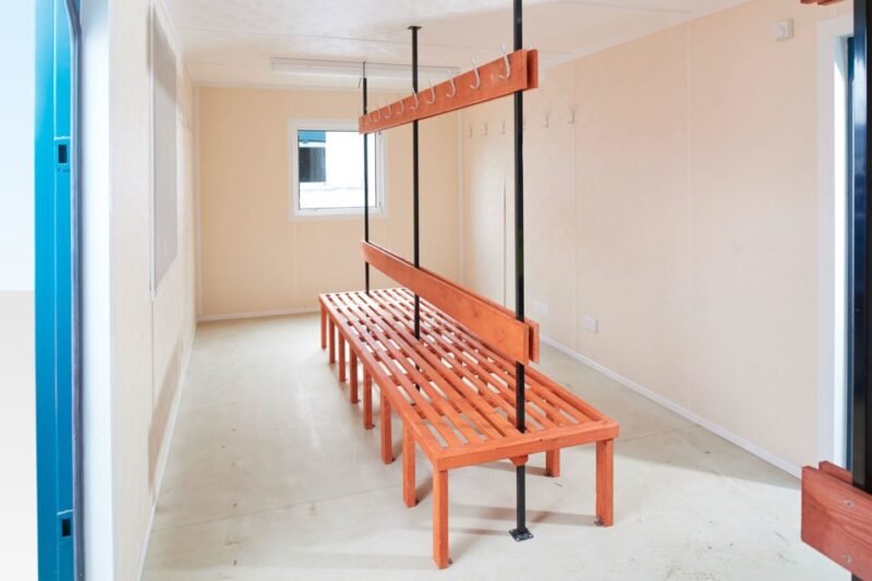 32 ft ECOlink Drying Room Cabin – Blue – Interior of a drying room with wooden benches and wall mounted coat hooks