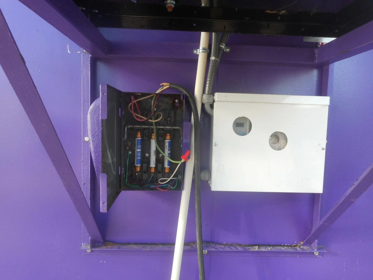 20ft Refurbished Cold Storage Container – Freezer/Cooler – open fuse box and electrical enclosure on purple wall