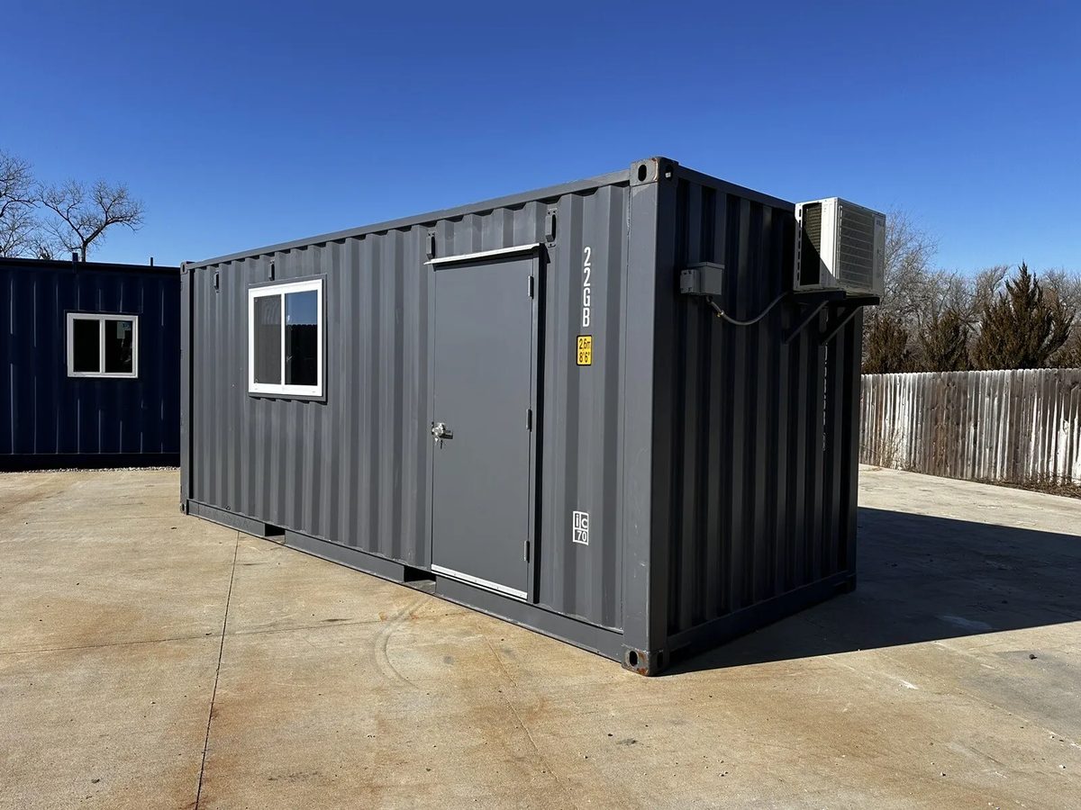 20ft Prefabricated Metal Office – Slate Gray Shiplap – Three-quarter exterior of gray container building with door and window