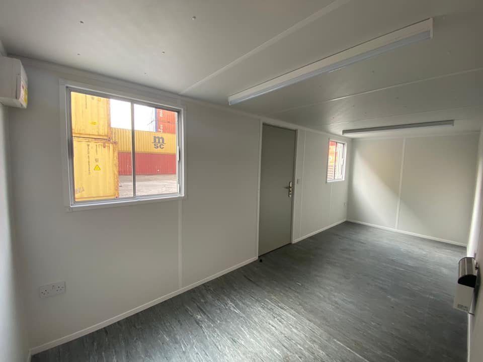 20ft Open-Plan Office Container – Flexible Workspace – empty office interior with windows and grey flooring