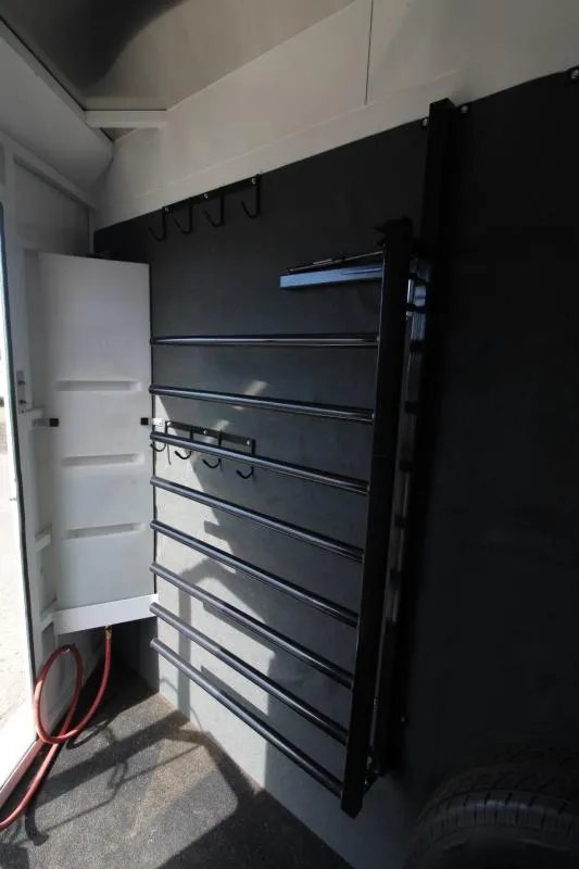2019 Trails West 4 Horse Trailer – Convenience Package – Detail of the blanket bar rack and bridal hooks in tack room