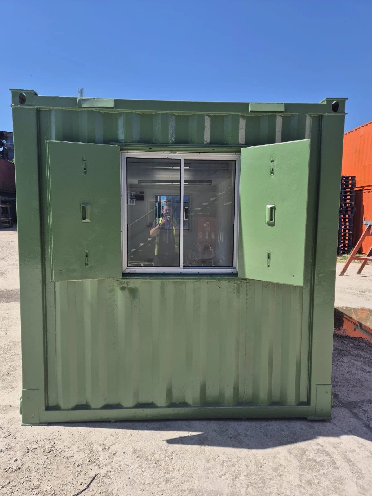 20ft Mobile Office Container – Green, Open Plan – green office container end with window and open steel shutters