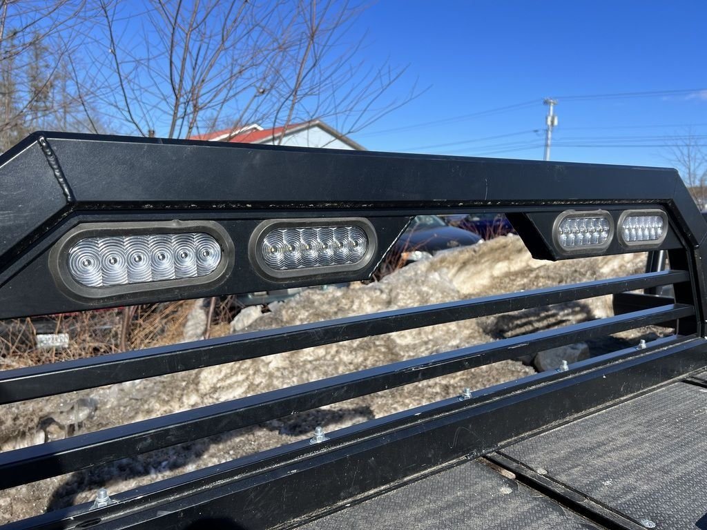 2023 Sno Pro 8 ft Sled Deck – Sliding Sides – Close-up of the LED work lights mounted on the headache rack