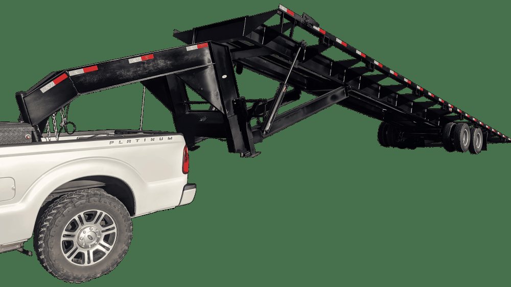 40 ft Gooseneck Tilt Bed Trailer – Eight Winches – Side profile of a black gooseneck tilt bed trailer hitched to a white truck