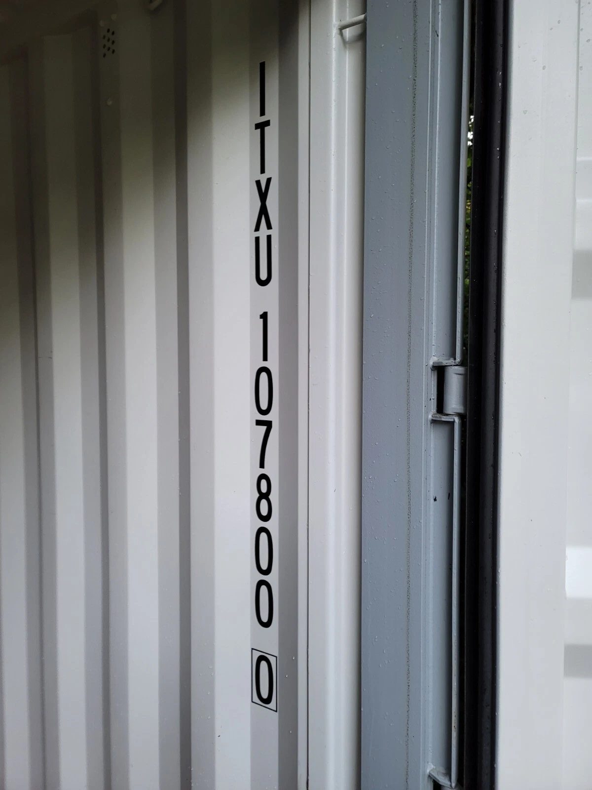 20ft Used Shipping Container – Wind & Watertight Storage – close-up of container identification markings and door hinge