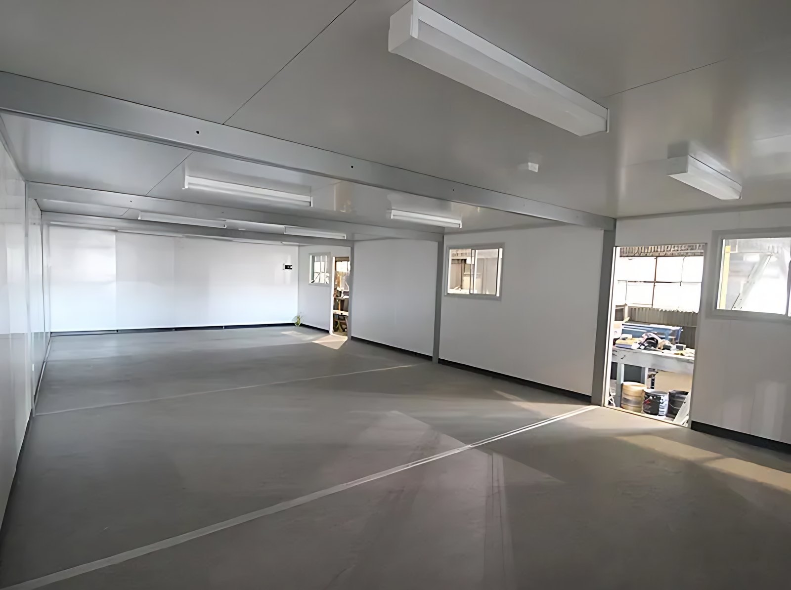 Custom Portable Steel Building – Office, Workshop or Storage – empty steel building interior with windows and ceiling lights