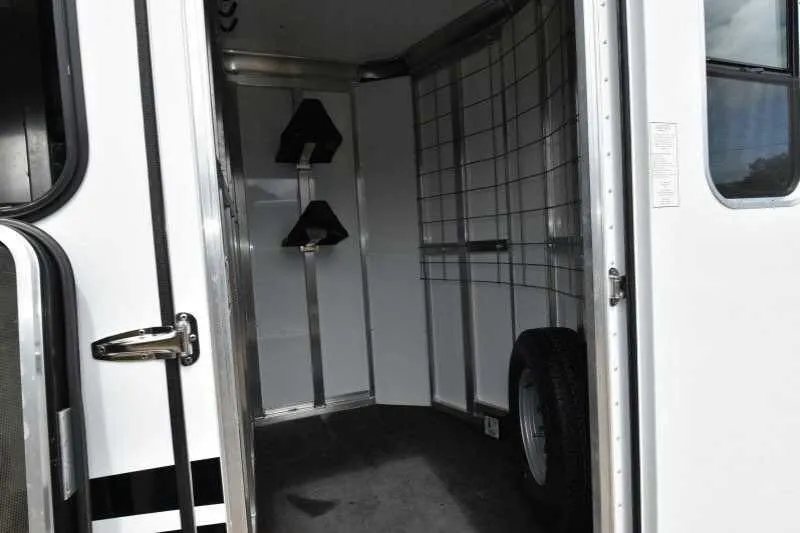 2016 Shadow 2 Horse Trailer – Aluminum, Dressing Room – Interior view of the tack room area with saddle racks and spare tire