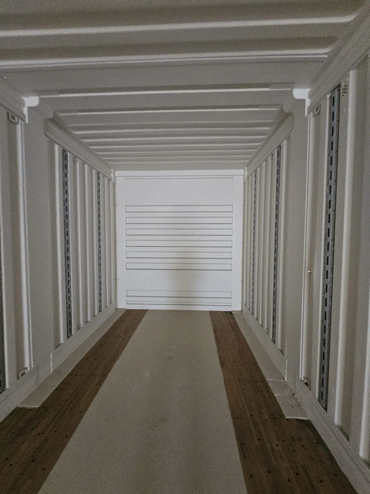 53ft High Cube Shipping Container – Used, Multi-Trip – empty container interior with white walls and wooden floor strips