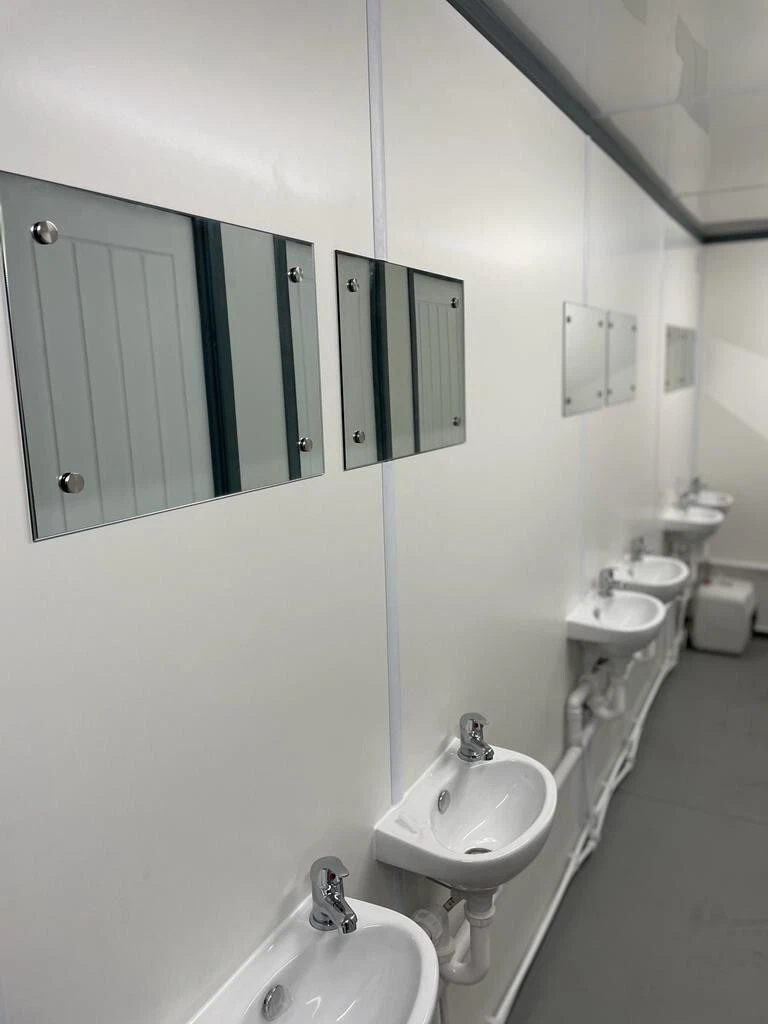 20ft Refurbished Container Toilet Block – Separate Compartments – row of white washbasins and mirrors inside toilet block
