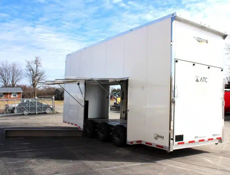2026 ATC 26 ft Stacker Trailer – Tiltable Lift – Rear three-quarter view of a white stacker trailer with open side escape door
