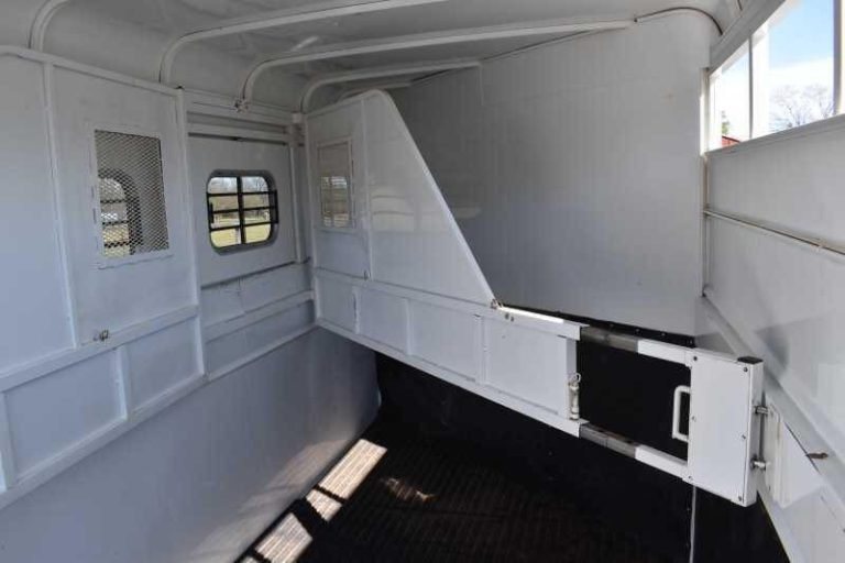 2002 Logan Coach 3 Horse Trailer – Steel, Dressing Room – Wide interior shot of the horse stalls with dividers partially open