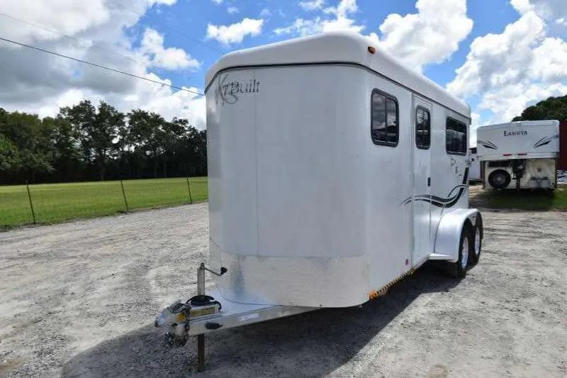 2002 Kiefer Built 2 Horse Bumper Pull – Dressing Room – Front three quarter view of white horse trailer with hitch assembly visible