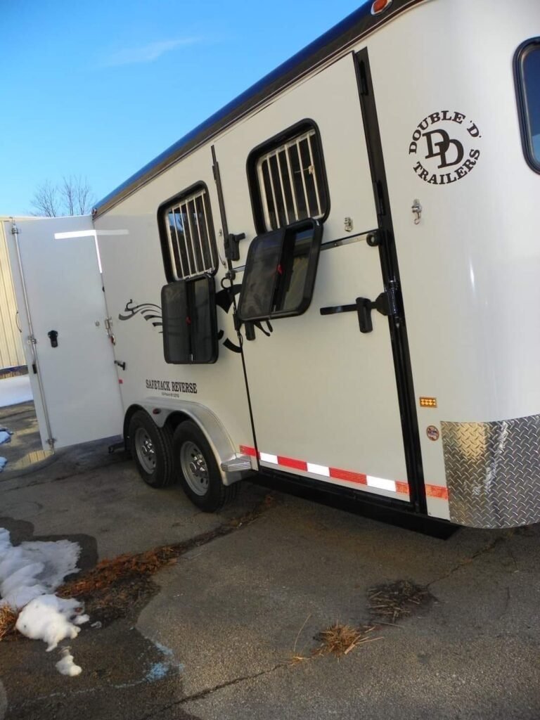 2022 Double D 2 Horse Bumper Pull – Reverse Slant – Three quarter view of the horse trailer side with doors open