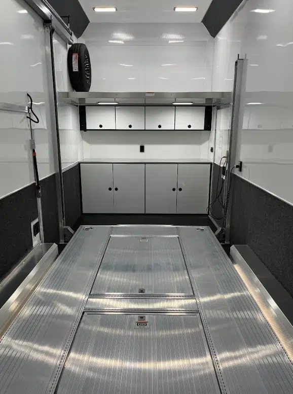 2026 ATC 22 ft Stacker – 14 ft Lift – Interior view of the trailer showing white upper cabinets and lower storage