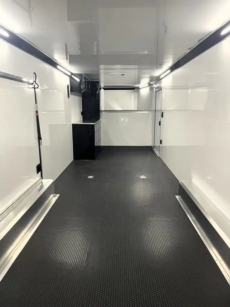 2026 ATC 40 ft Gooseneck – Black Trim – Clean white interior with black cabinets and black flooring looking toward the front