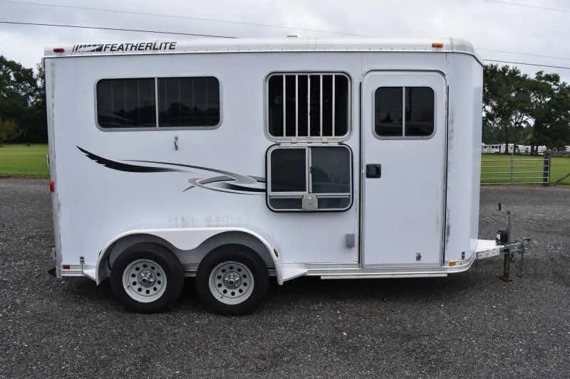 2003 Featherlite 2HST 2 Horse Trailer – Aluminum – Full passenger side view showing the entry door and drop down windows