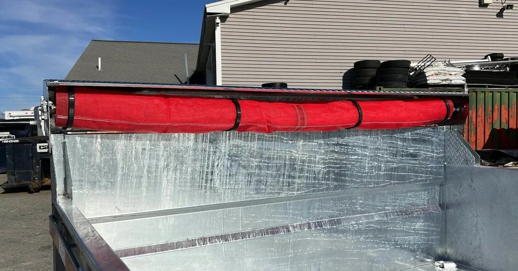 2024 N&N Trailers 14 ft Dump – Galvanized Steel – Front view of the rolled red mesh tarp kit mounted on the bed