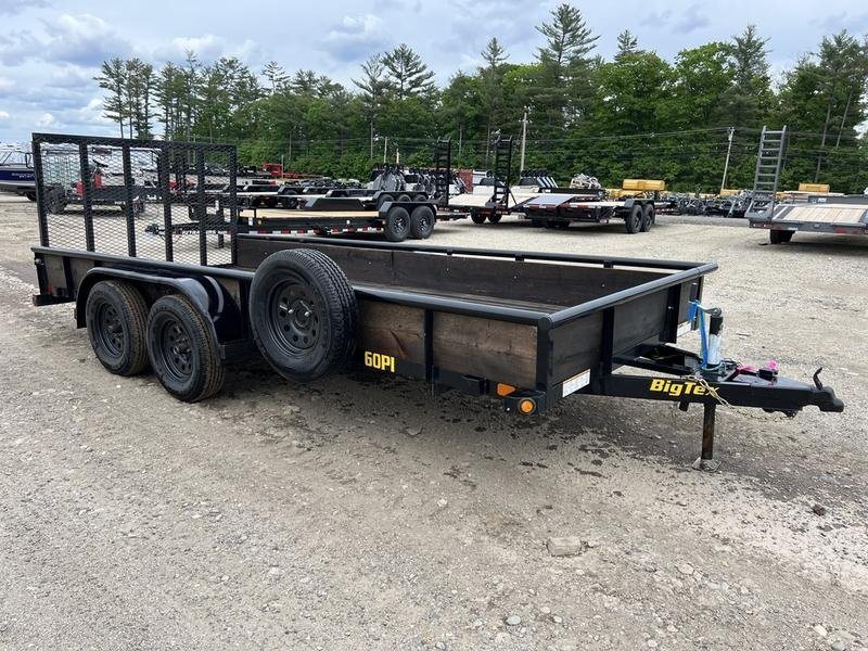 2021 Big Tex 16 ft Utility Trailer – Ramp Gate & Spare – Three-quarter front view of a black tandem axle utility trailer with wooden side panels