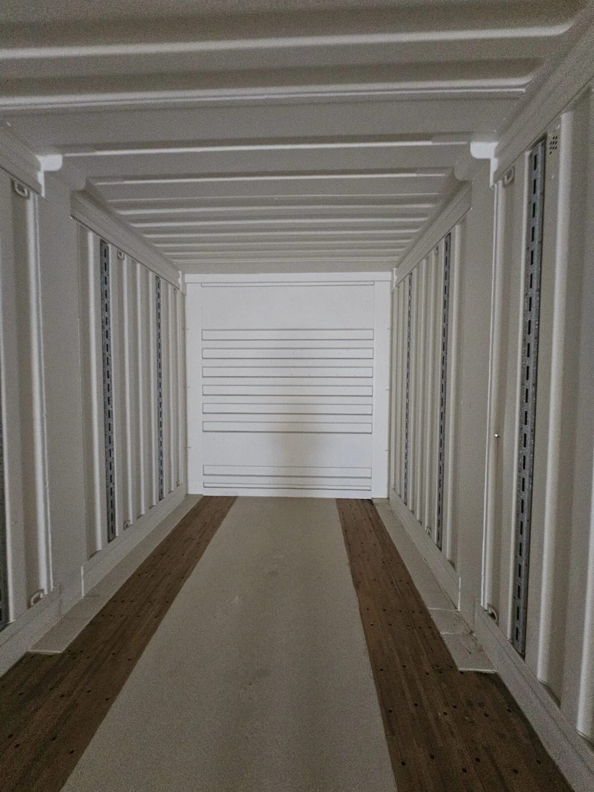 53ft High Cube Shipping Container – Used, Multi-Trip – empty container interior with white walls and wooden floor strips