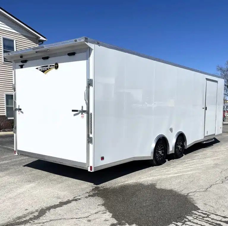 2026 Millennium 26 ft Car Hauler – White Aluminum – Rear three-quarter view of the white trailer showing the rear ramp door closed