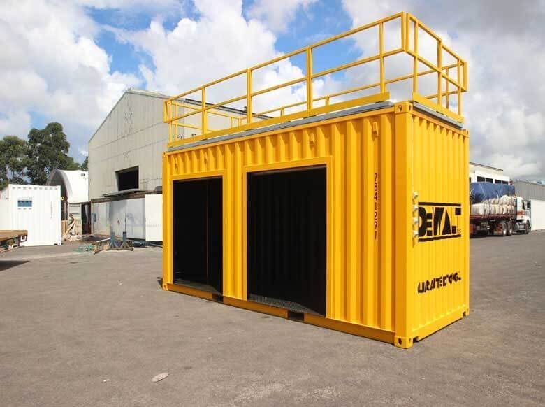 Trade Show Display Container – Lockable Steel Booth – Three quarter view of the yellow container unit with open roller door bays