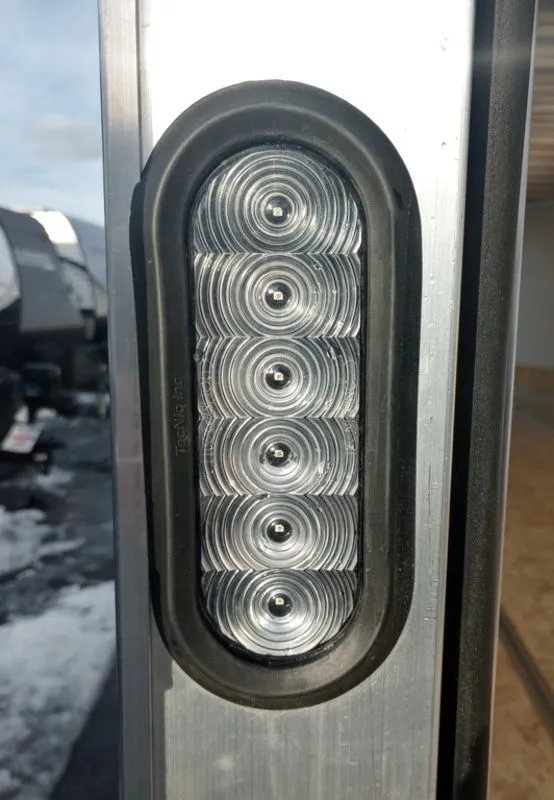 2024 Mission Trailers 24 ft Deckover – Galvanized Package – Close-up of an oval LED tail light mounted on the trailer frame