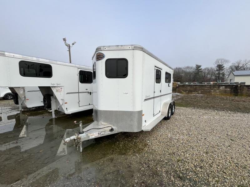 2019 Sundowner Charter 2 Horse Trailer – Warmblood Size – A three-quarter front view of a white horse trailer parked on a gravel lot