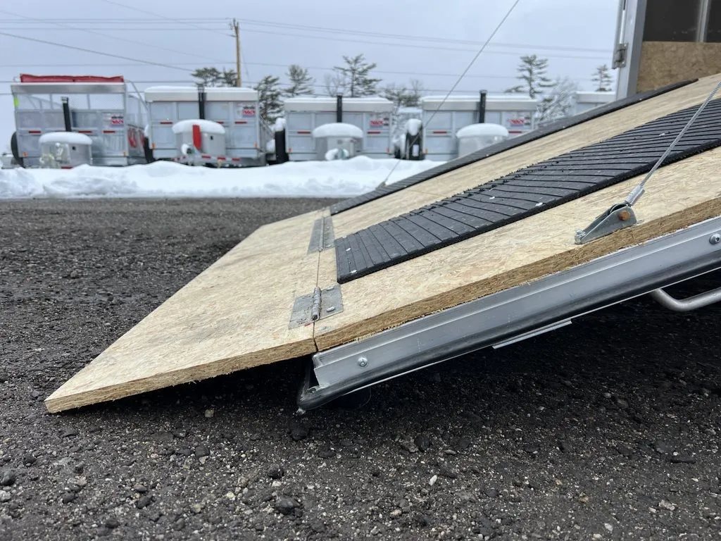 2022 High Country 12 ft Hybrid Trailer – Track Mats – Detailed view of the ramp hinge and the edge of the wooden ramp