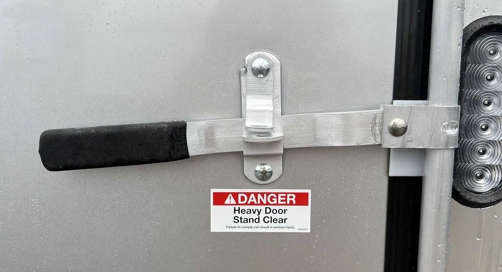 2024 Mission Trailers Crossover Trailer – Galvanized Package – Detail of the rear ramp door locking latch and handle