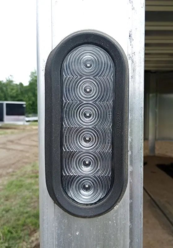 2022 Sno Pro Trailers Hybrid 2.0 – Charcoal Snowmobile Trailer – Close-up of a clear vertical LED tail light mounted on a trailer frame