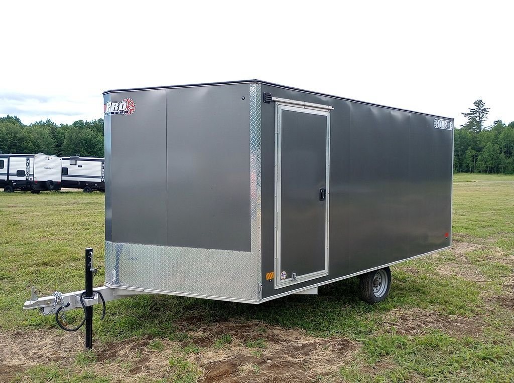 2022 Sno Pro Trailers Hybrid 2.0 – Charcoal Snowmobile Trailer – Front three-quarter view of a charcoal grey hybrid snowmobile trailer on grass