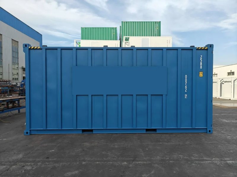 20 ft Bulk Dry Cargo Container – Blue – A straight-on side view of the blue steel bulk storage container in an industrial yard