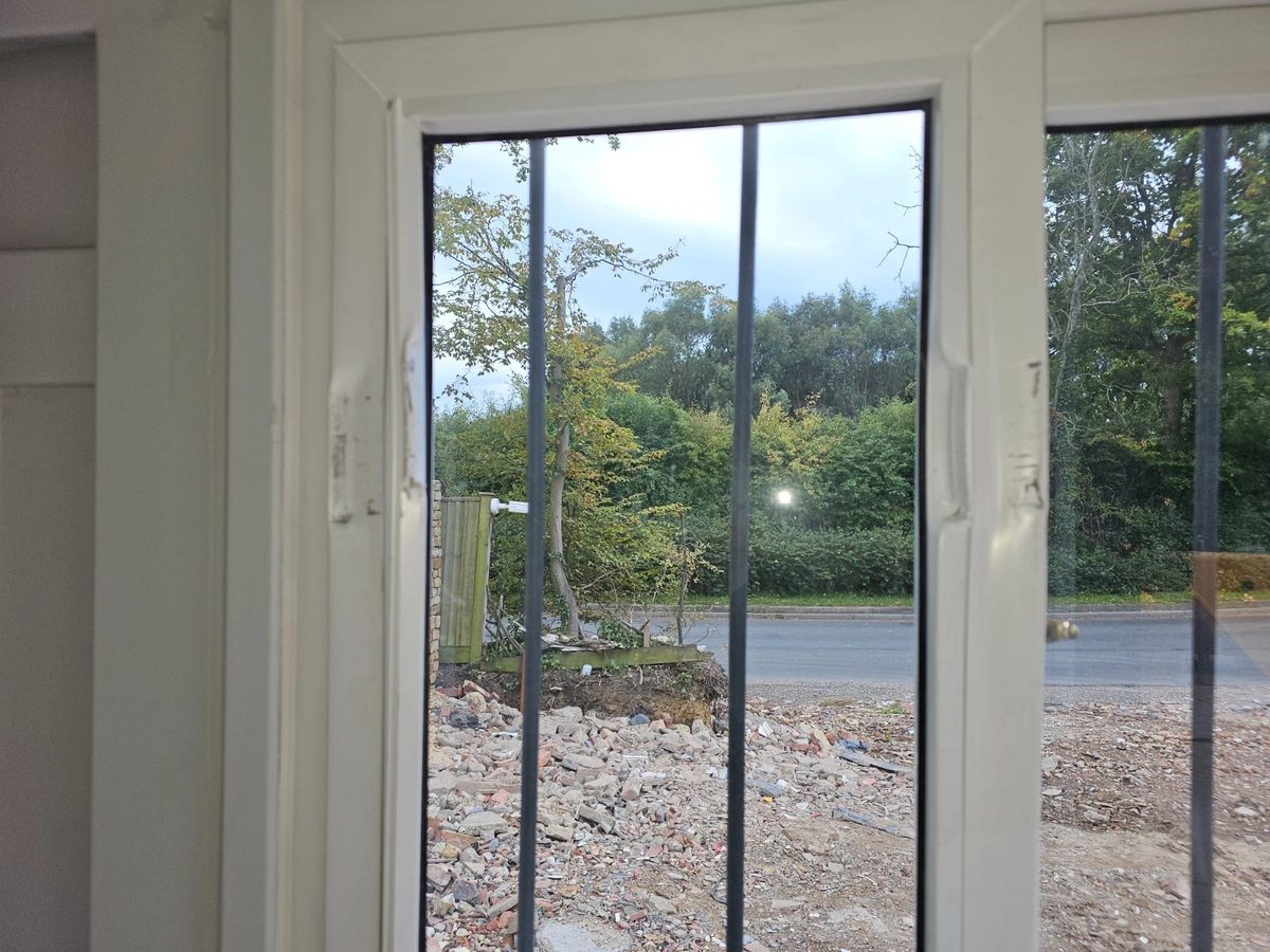 8ft New Shipping Container – Lockbox and Barred Windows – interior closeup of white framed windows with security bars