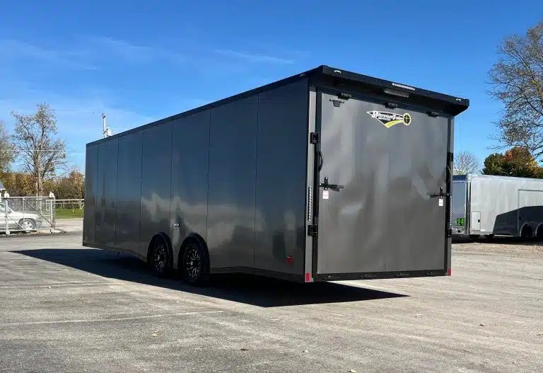 2025 Millennium 26 ft Car Hauler – Charcoal – Rear view of the trailer showing the closed ramp door and rear loading lights