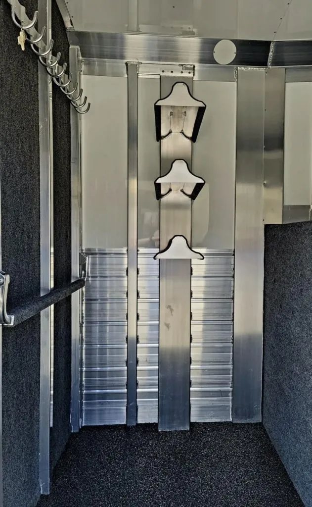 2023 4 Star 23 ft Horse Trailer – 2+1 Gooseneck – Close up of the adjustable saddle tree and bridle hooks in tack room