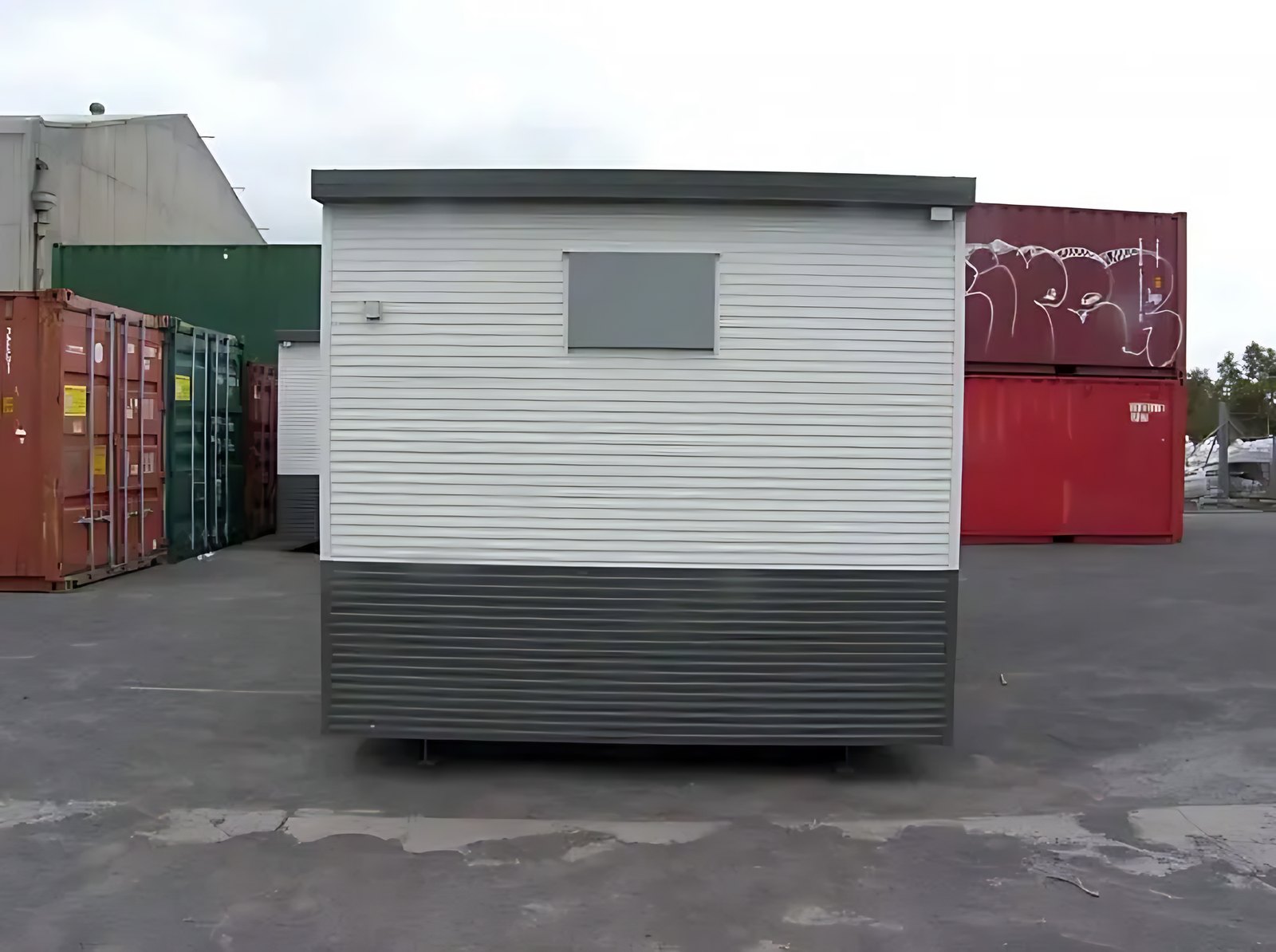 Custom Portable Steel Building – Office, Workshop or Storage – front exterior of portable building in container storage yard