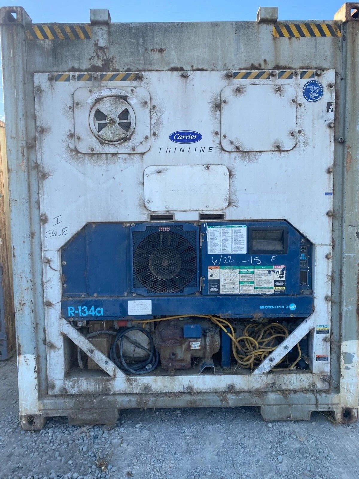 40ft Used Refrigerated Shipping Container – Custom Side Door – weathered refrigerated container end with exposed refrigeration equipment