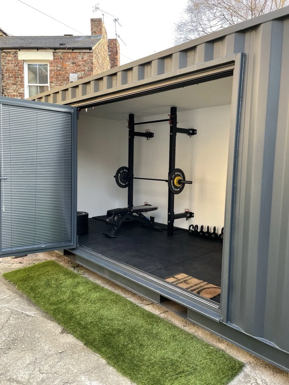 20ft Converted Container Office – Private Gym Configuration – open container doorway revealing gym equipment and rubber flooring