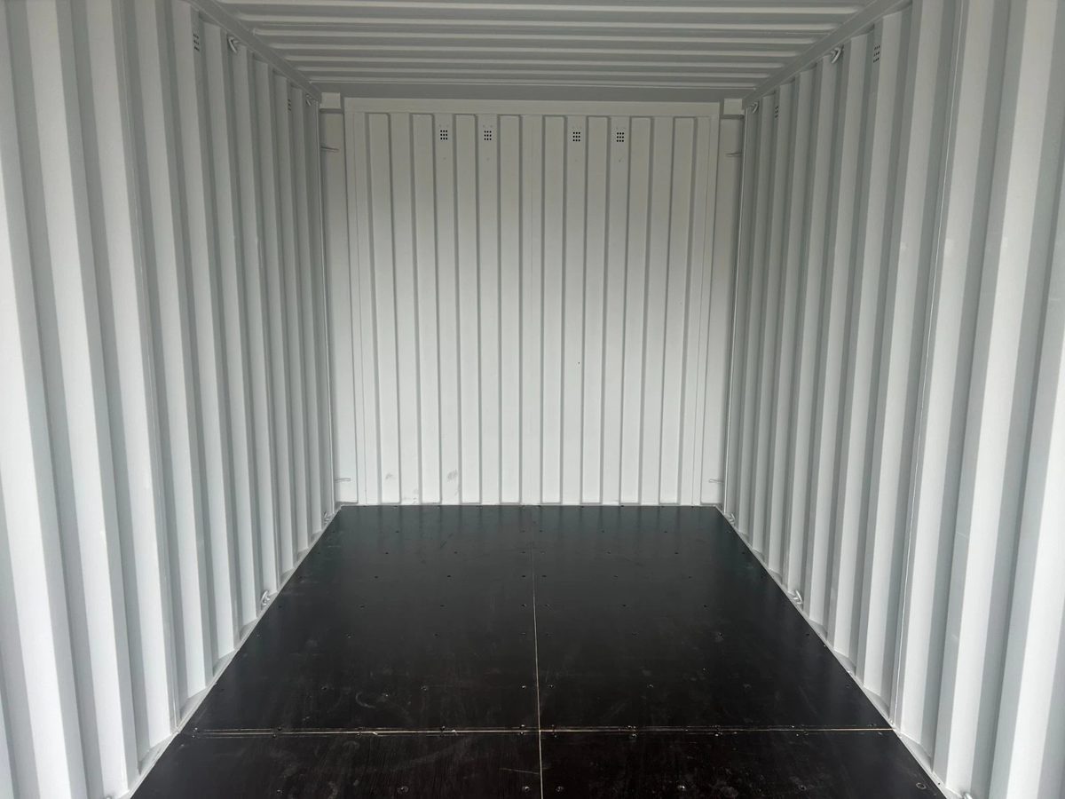 20ft New Shipping Container – One-Trip, Double Doors – empty container interior with light walls and dark flooring