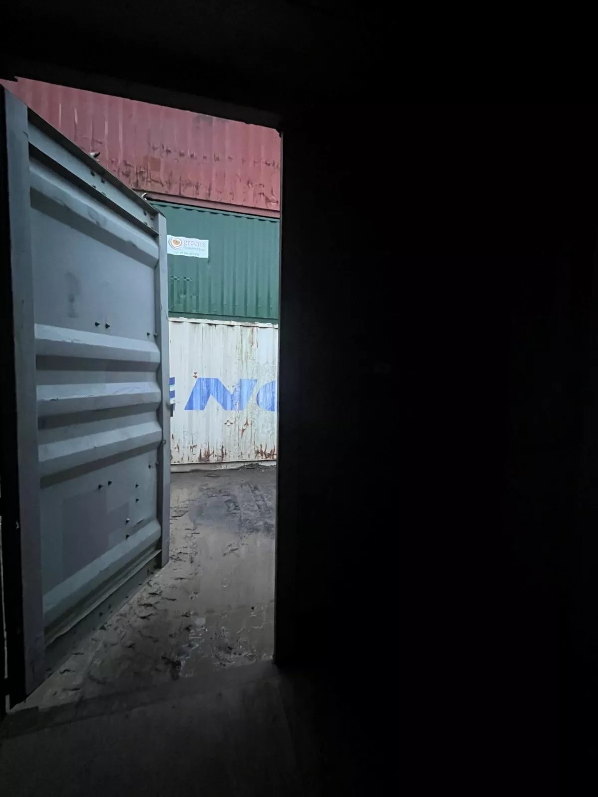 40ft Used High Cube Shipping Container – Lockable Cargo Doors – Open cargo door viewed from a dark container interior