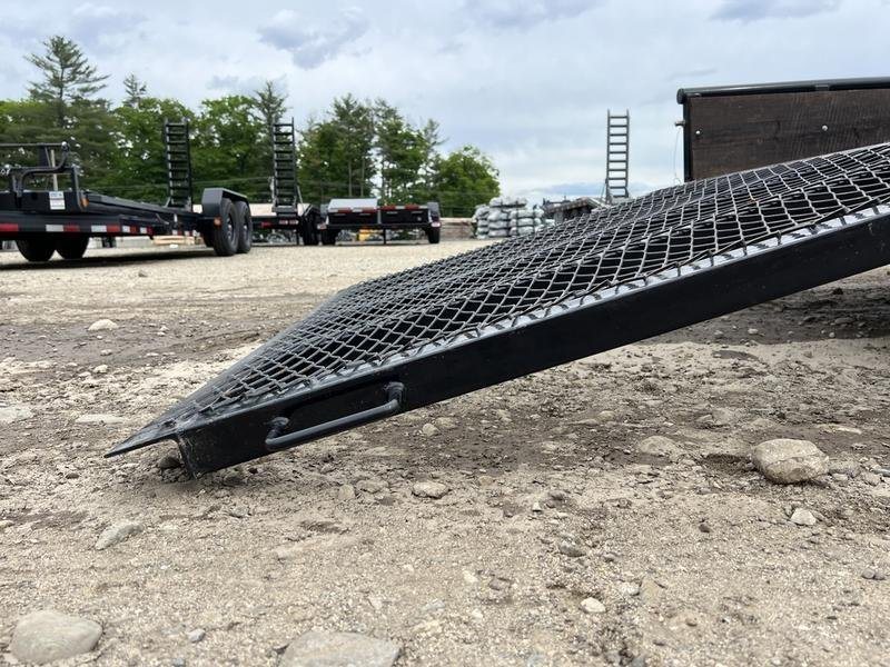 2021 Big Tex 16 ft Utility Trailer – Ramp Gate & Spare – Low angle view of the mesh ramp edge resting on the dirt ground