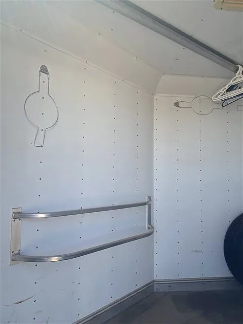 2000 Sooner 4 Horse Bumper Pull – Dressing Room, Awning – Wall inside the tack room with blanket bars and white panels