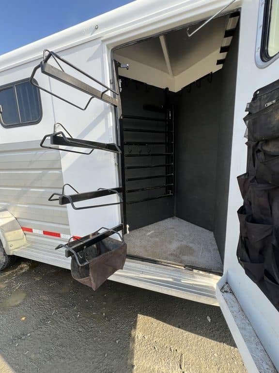2020 Trails West Sierra 4 Horse Gooseneck – Comfort Package – Open tack room door showing bridle hooks and saddle storage