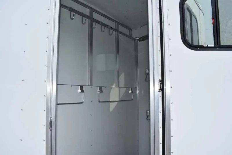 2019 Trailers USA 2 Horse Trailer – Aluminum, Dressing Room – Interior tack area with bridle hooks and metal storage racks visible