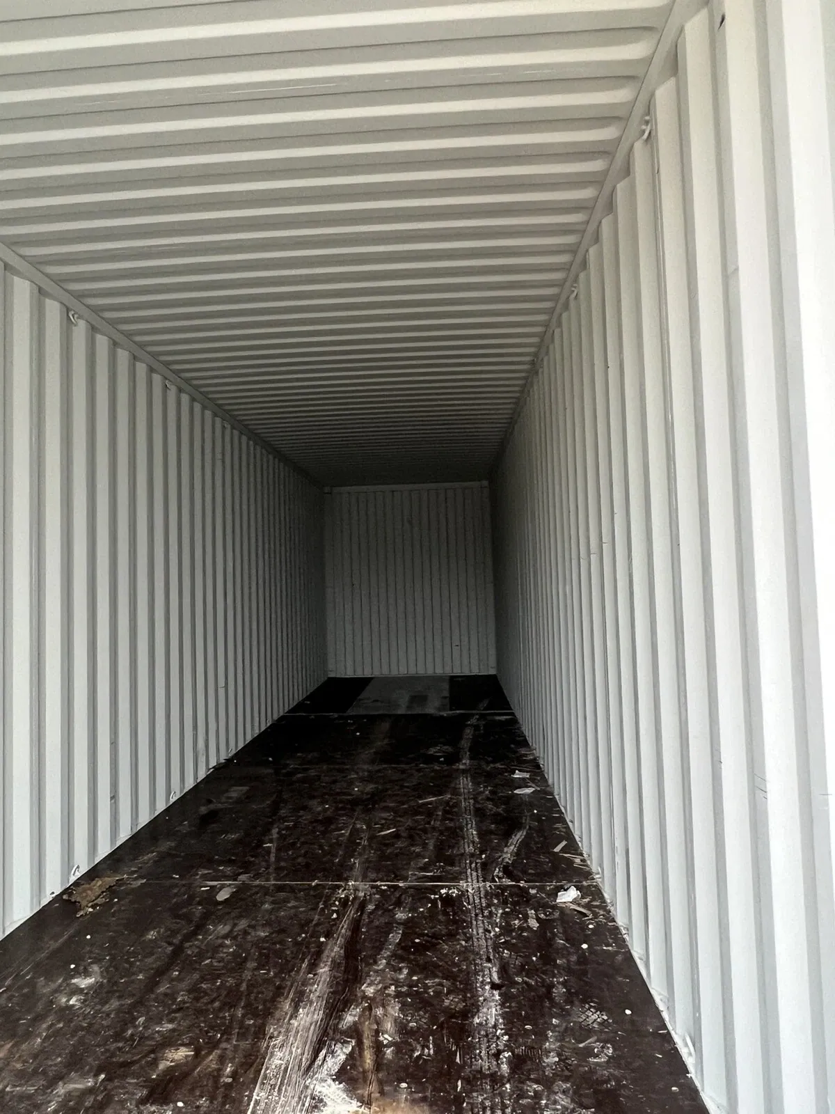 40ft High Cube Shipping Container – One-Trip, Double Doors – empty container interior with corrugated walls and scuffed wooden floor