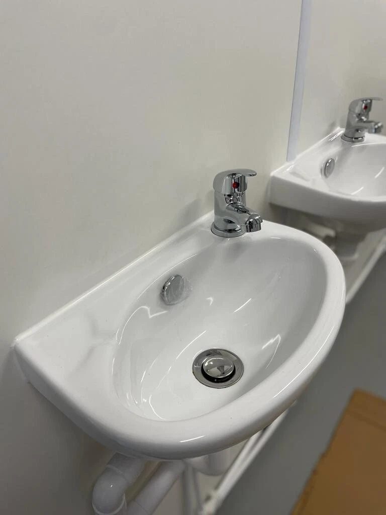20ft Refurbished Container Toilet Block – Separate Compartments – two white wall-mounted washbasins with chrome taps
