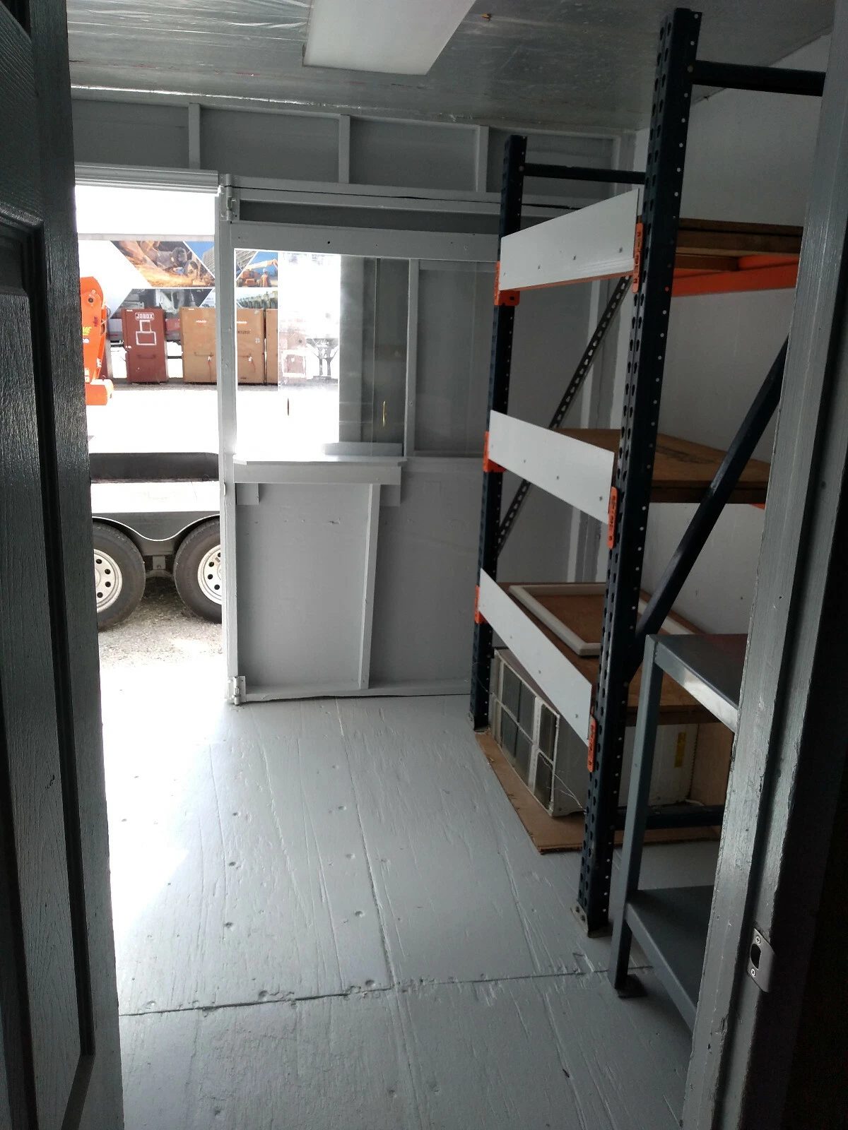 40ft High Cube Container Office – Storage Racking, Side Access – container storage interior with metal racking and open doorway
