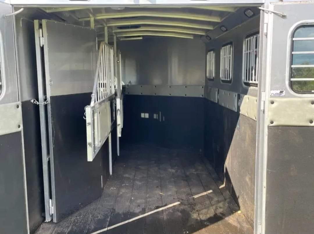 2005 Classic 16 ft 3 Horse Trailer – Dual Tack – The empty interior horse stalls with rubber matting and metal dividers