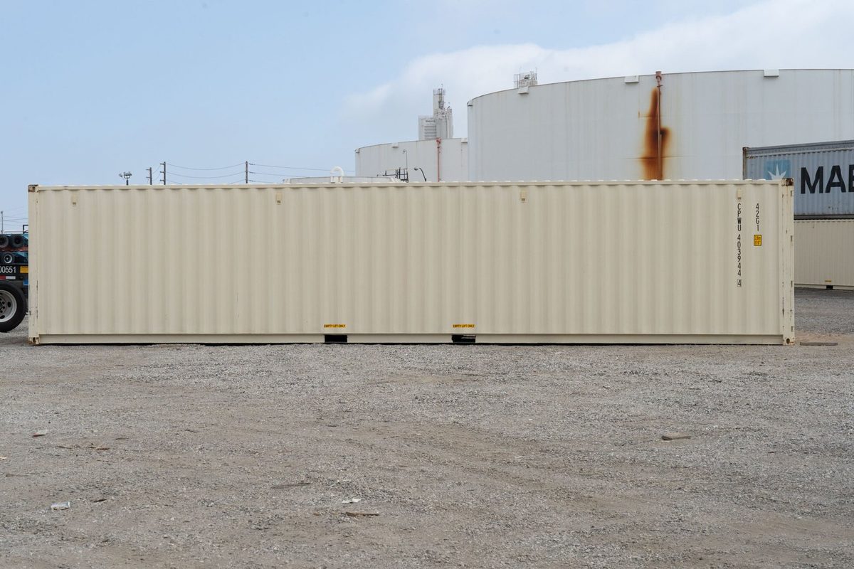 40ft Standard Shipping Container – New One-Trip – full side view of cream shipping container in industrial yard